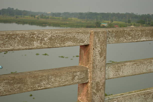 Scenic view of riverbank from bridge during calm sunset evening