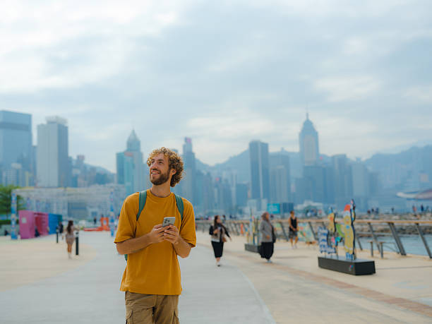istock Man using smartphone walking in Hong Kong 2214895490