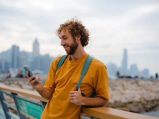 Man using smartphone walking in Hong Kong