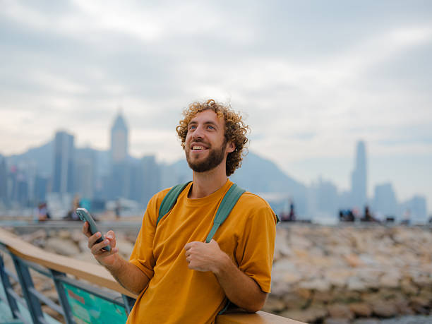 istock Man using smartphone walking in Hong Kong 2214895747