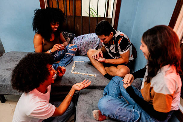 istock Young friends playing domino at home 2214900118
