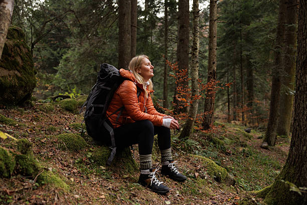 Woman Sitting Peacefully in Autumn Forest Setting