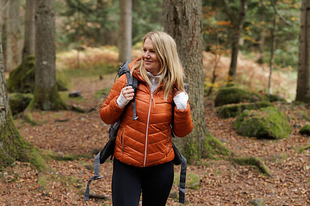 istock Woman Enjoying a Peaceful Hike Through the Forest 2214901262