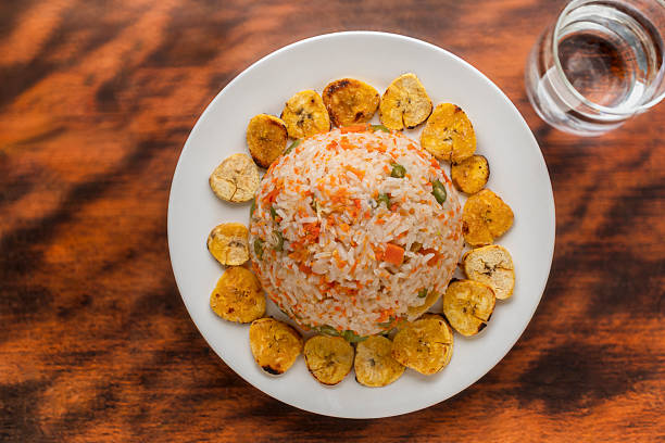 Fried rice with vegetables, patacones, and chicken