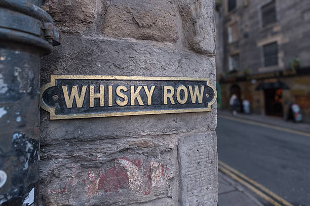 istock Old Whisky row road sign on a wall 2214903247