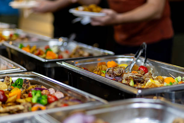 istock Buffet spread featuring a variety of dishes at a gathering event in the evening 2214903864