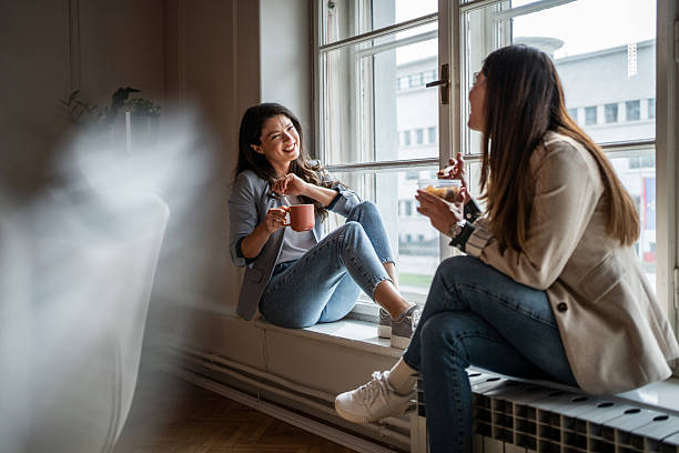 istock Two businesswomen enjoying coffee break by the window 2214908980