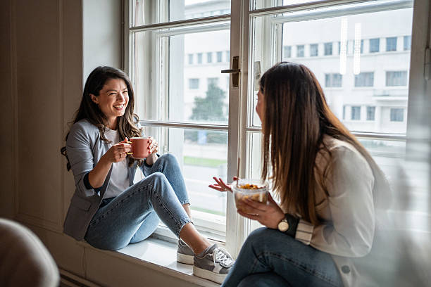 istock Two young businesswomen enjoying coffee break by the window 2214908989
