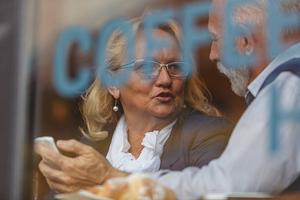 istock Senior couple enjoying coffee time together and engaged in conversation 2214910080