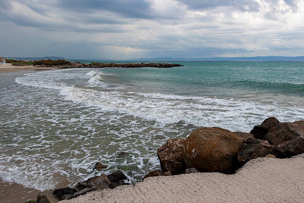Beatiful stormy Black Sea shoreline beach view from a concrete pier at Pomorie, Province of Burgas, Bulgaria