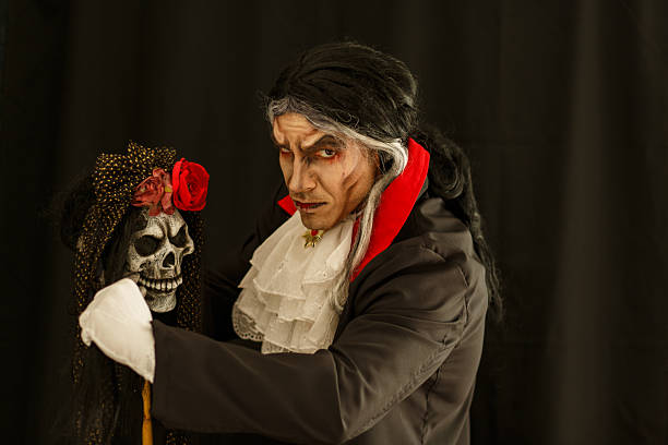 Dramatic vampire character with skull and gothic decorations in eerie ambiance