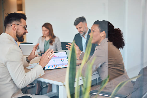 istock Business team analyzing financial data on a digital tablet during a meeting 2214925158