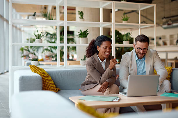 istock Business partners discussing over laptop in modern office 2214925834