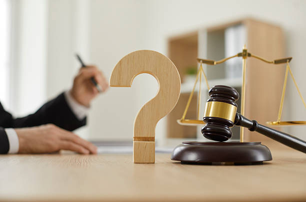 Close up of a question mark and gavel on the table in the courtroom or lawyer's office stock photo