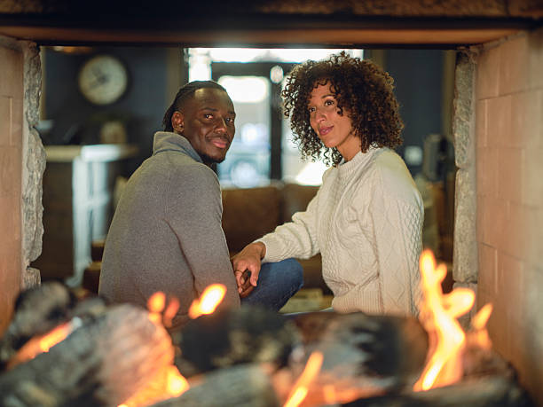 istock Young Couple at a Ski Lodge Sitting by the Fireplace 2214926319