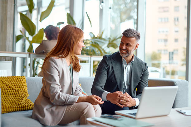istock Business partners discussing a project in modern office using laptop 2214926322