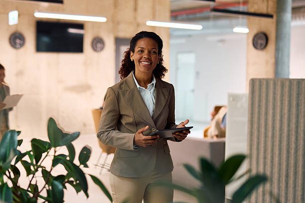 istock Smiling businesswoman using digital tablet in modern office 2214926341