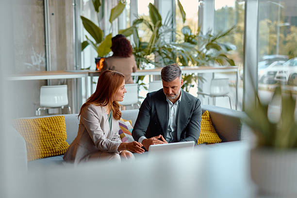 istock Business partners discussing a project using a laptop in a modern office 2214926357
