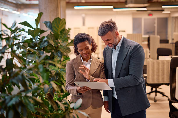 istock Business colleagues reviewing a document in modern office 2214926774