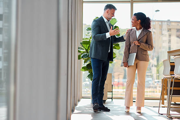 istock Business partners discussing strategy in modern office building lobby 2214928625
