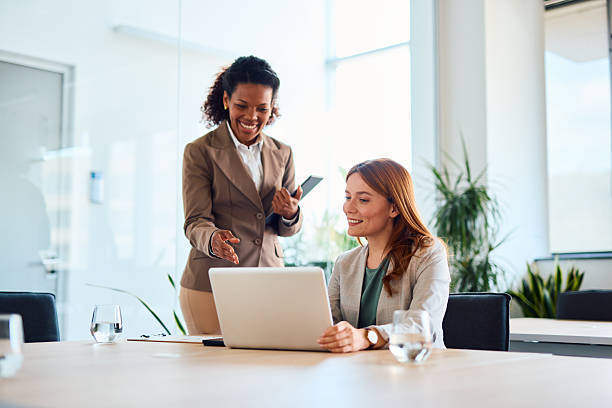 istock Two businesswomen collaborating on a project using a laptop in the office 2214928749