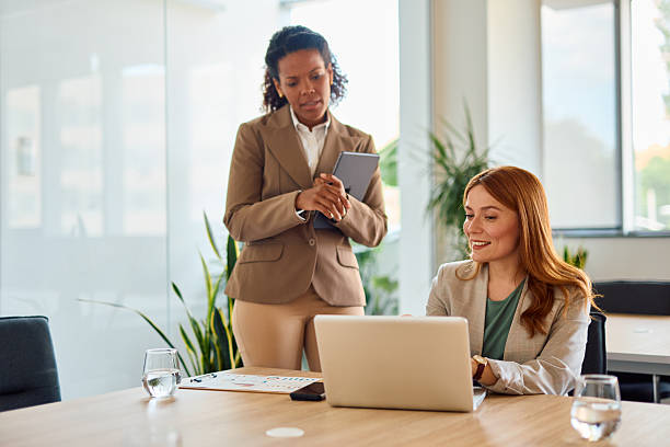 istock Businesswomen collaborating on a project using laptop and tablet in the office 2214928804