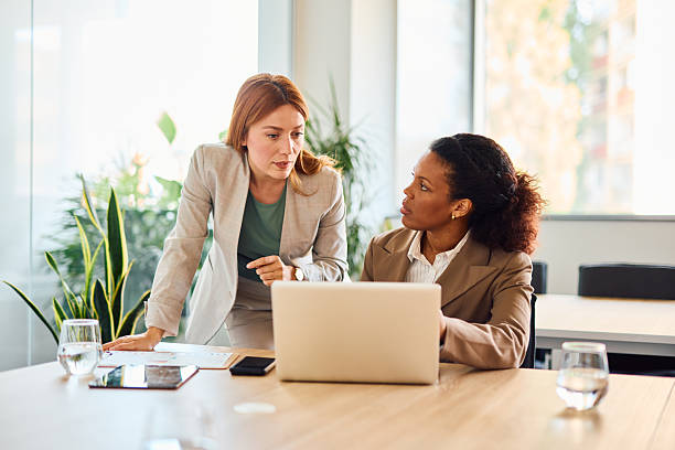 istock Businesswomen working together analyzing data on laptop in modern office 2214928877