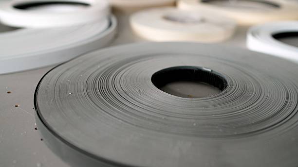 istock Gray pvc edge banding tape unwinding on table 2214929344