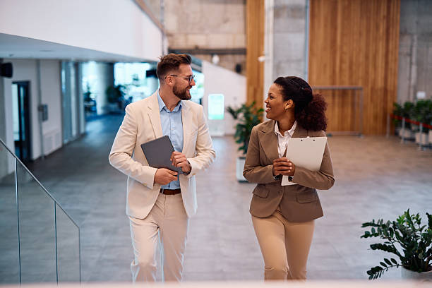 istock Business people walking and talking in modern office building 2214929665