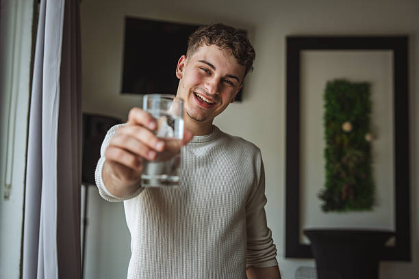 istock One young man portrait drinking water 2214932765