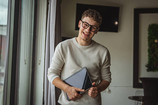 istock One young man holding tablet portrait 2214932792