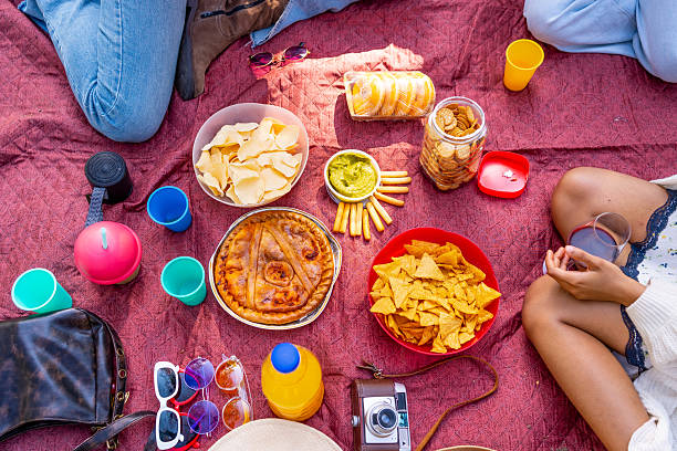 istock Friends enjoying a delicious picnic with savory snacks and refreshing drinks 2214937340