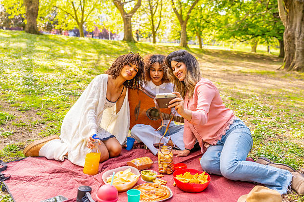 istock Three young women taking a selfie at a picnic in the park 2214937370
