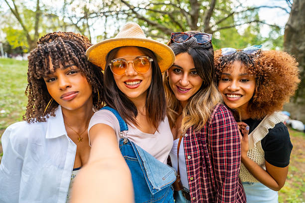 istock Four young women taking a selfie in the park 2214938036