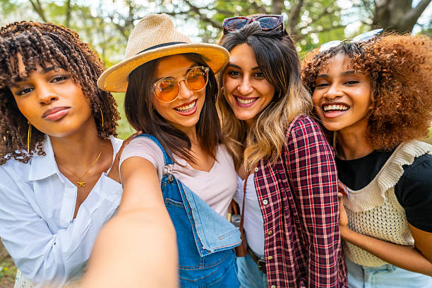 istock Four young women taking a selfie in the park 2214938038