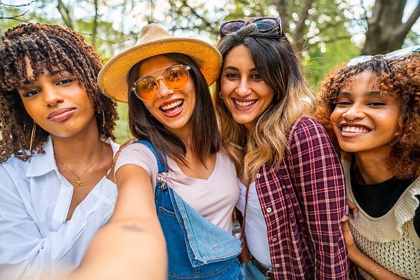 istock Four young women taking a selfie in a park 2214938042