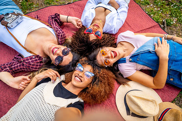 istock Four young women taking a selfie lying on a blanket 2214938073