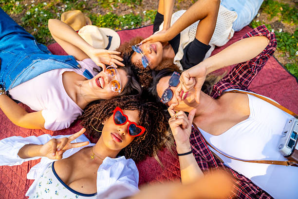 istock Four young women taking a selfie lying on a blanket 2214938102