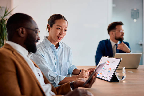 istock Business people analyzing financial data on tablet during a meeting 2214938977
