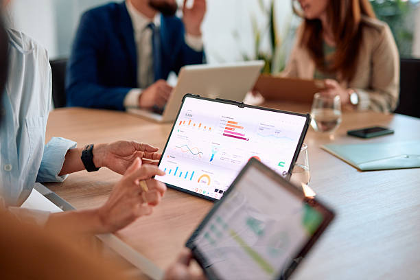 istock Business team analyzing financial data on digital tablets during a meeting 2214939121