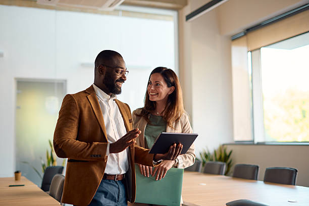 istock Business partners discussing using digital tablet in modern office 2214940782
