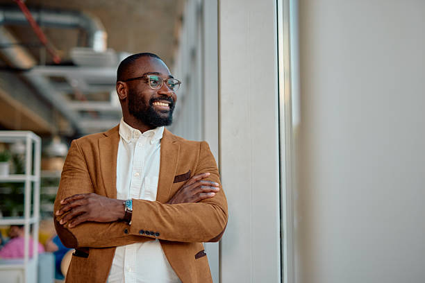 istock Confident businessman looking out the window in modern office 2214941384