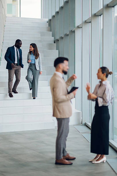 istock Business people walking and talking in modern office building 2214945731
