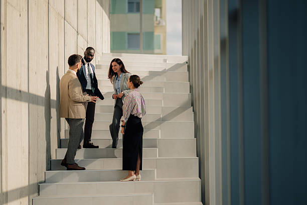 istock Businesspeople talking on stairs during informal meeting 2214945766