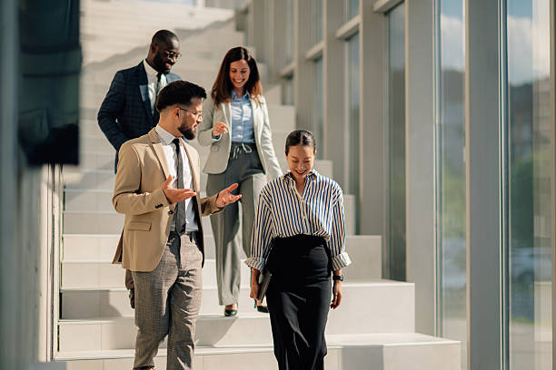 Business people walking downstairs in modern office building