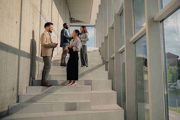 istock Business people talking on stairs in modern office building 2214945803