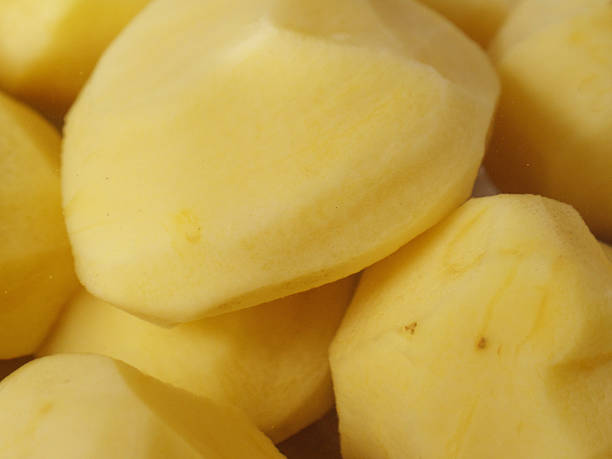 istock Freshly peeled potatoes displaying smooth, clean surfaces with raw, uncooked texture 2214945847