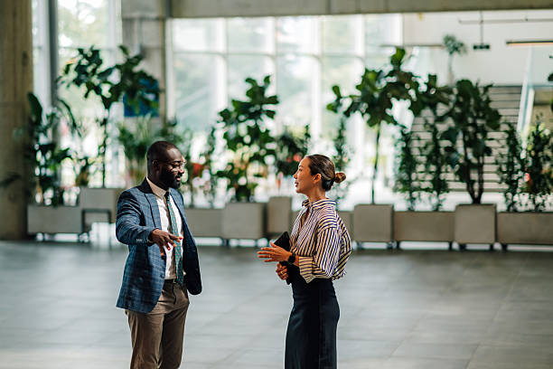 istock Businesspeople discussing strategy in modern office building lobby 2214945888