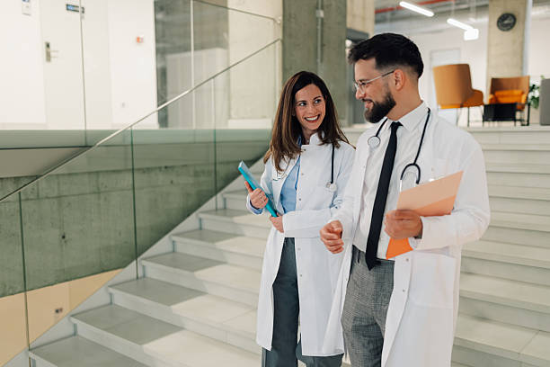 istock Doctors walking and talking on hospital stairs 2214947485