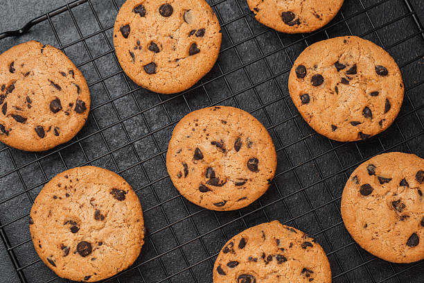 istock Delicious freshly baked chocolate chip cookies cooling on a wire rack 2214951749